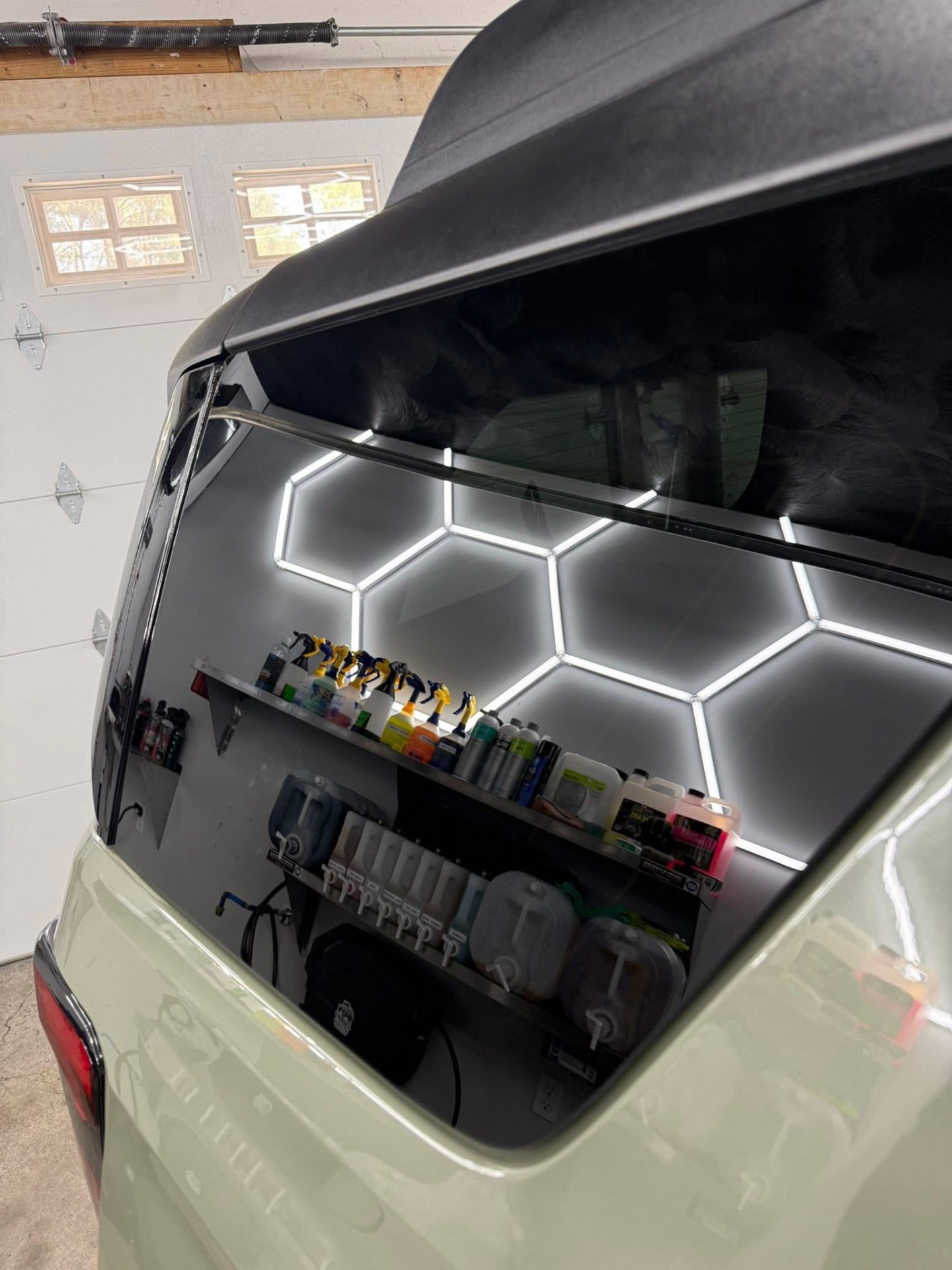 Rear window and hatch reflecting the shop's hexagon lights