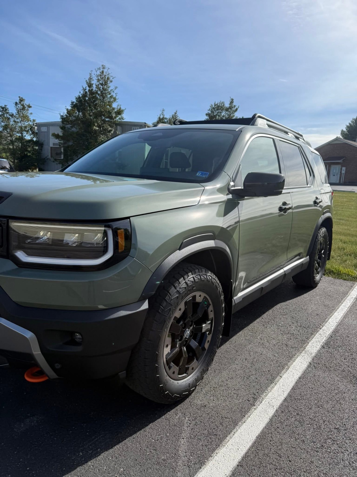 Olive-green SUV parked outdoors after a full detail
