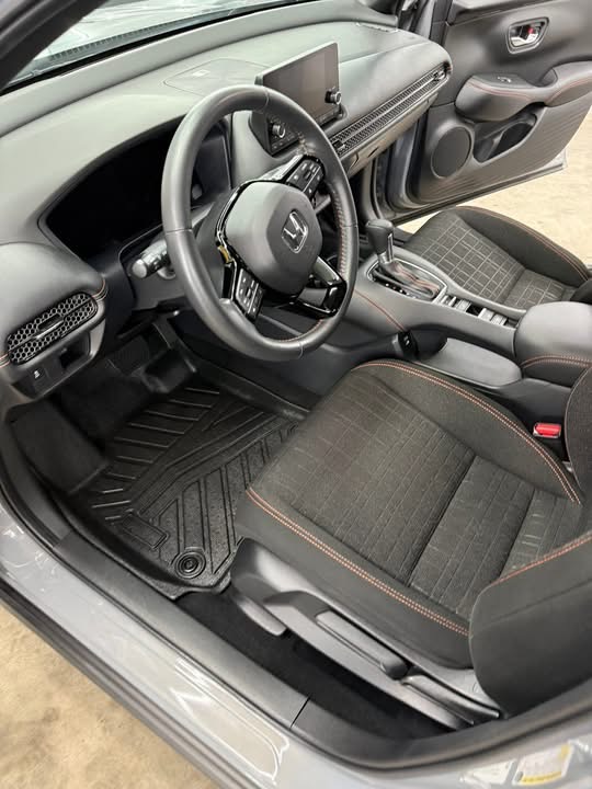 Freshly detailed car interior with cleaned dash, steering wheel and floor mats